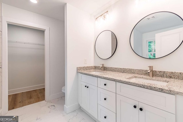 bathroom featuring vanity and toilet