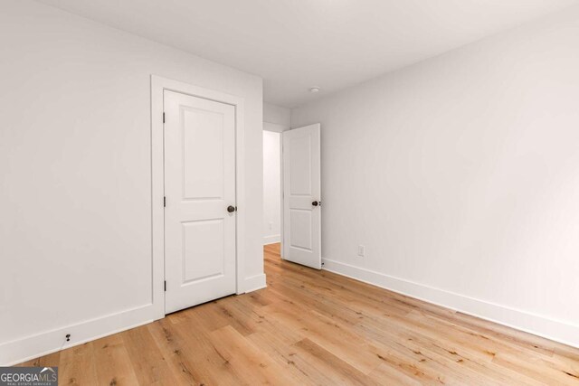 empty room with light hardwood / wood-style floors