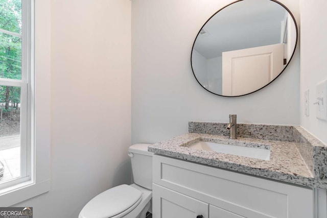 bathroom featuring toilet and vanity