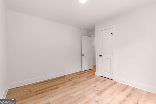 spare room with light hardwood / wood-style flooring