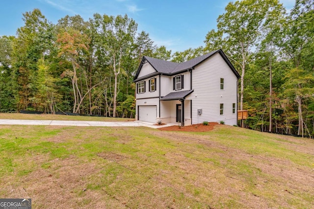 view of front of house featuring a front yard and a garage