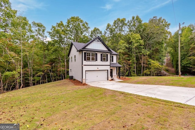 view of property featuring a front yard and a garage