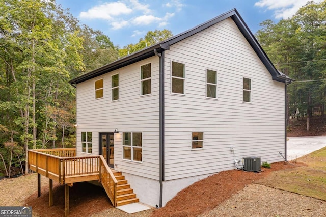 view of side of property with a wooden deck and central air condition unit