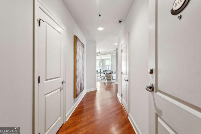 hall with hardwood / wood-style floors