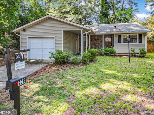 single story home with a garage and a front yard