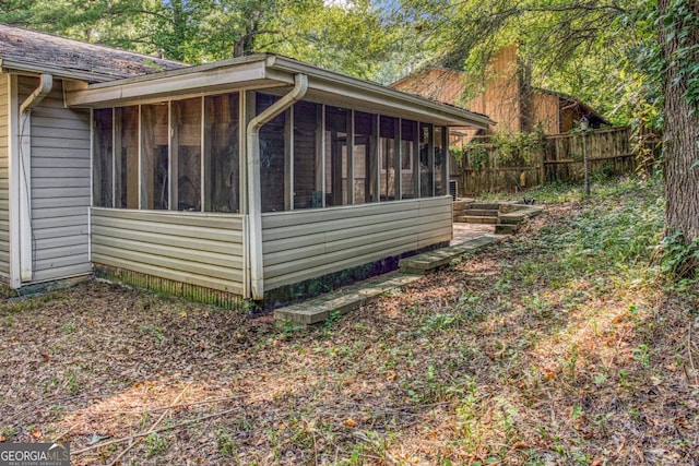 view of side of property featuring a sunroom