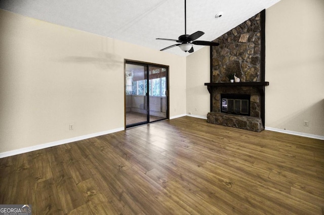 unfurnished living room with a textured ceiling, dark wood-type flooring, a fireplace, vaulted ceiling, and ceiling fan