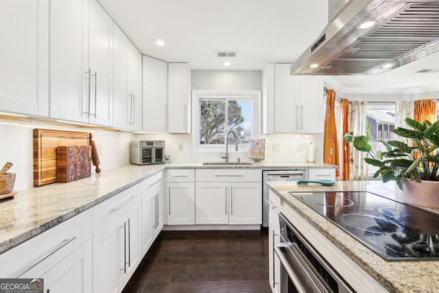 kitchen with dark wood-type flooring, white cabinetry, sink, ventilation hood, and black stovetop