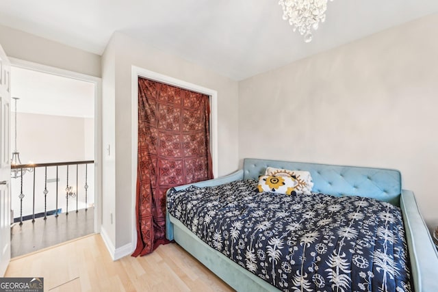 bedroom featuring hardwood / wood-style floors and a notable chandelier