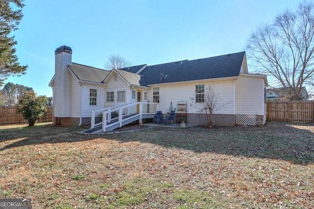 back of property featuring a yard