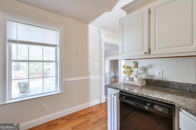 kitchen featuring white cabinetry, dishwasher, light hardwood / wood-style floors, and dark stone countertops