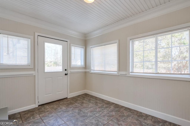 doorway featuring ornamental molding and dark tile patterned floors