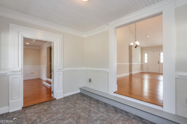 unfurnished room with crown molding, a chandelier, and dark wood-type flooring