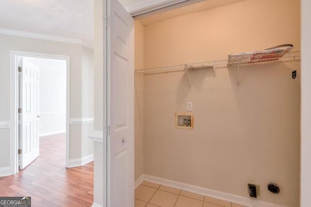 clothes washing area with electric dryer hookup, washer hookup, and crown molding