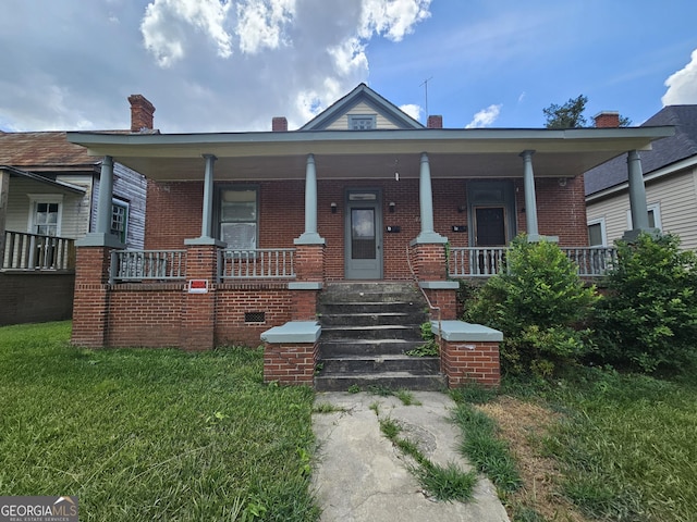 bungalow-style house with covered porch and a front yard