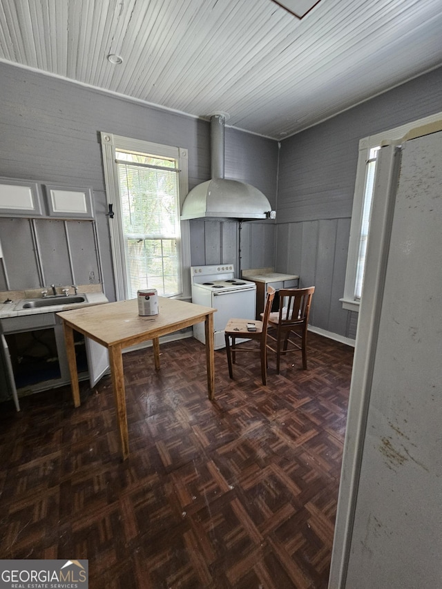 dining space with sink, dark parquet flooring, and washer / dryer