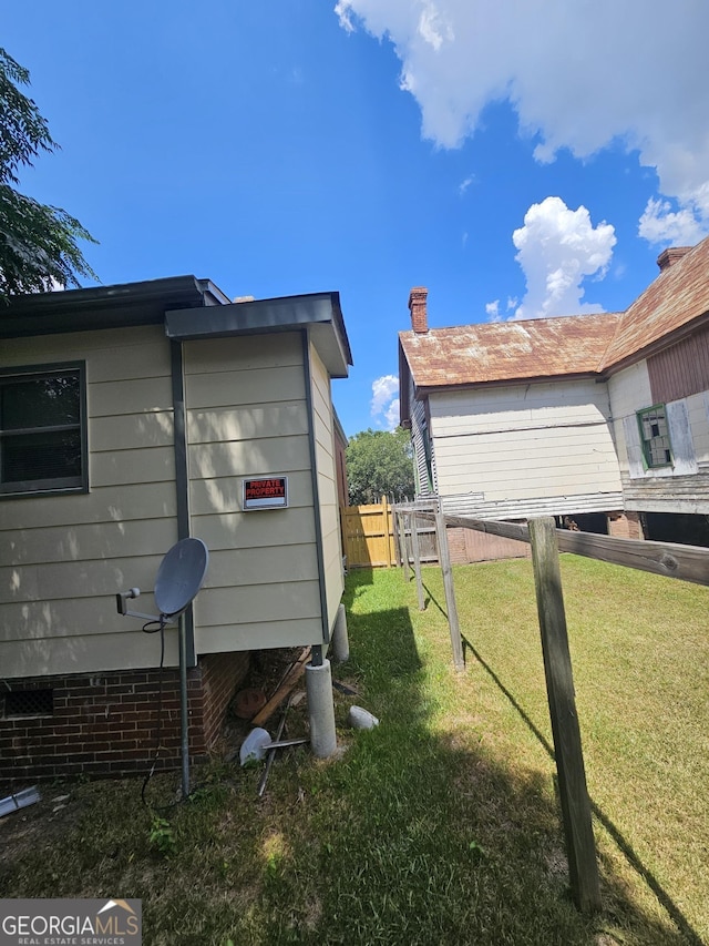 view of side of property with a lawn