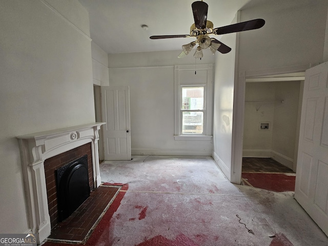 unfurnished living room featuring a brick fireplace, ceiling fan, and carpet flooring