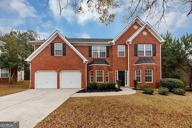 view of front of property with a garage and a front lawn