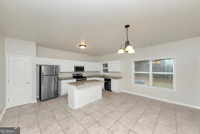 kitchen featuring sink, white cabinets, pendant lighting, and stainless steel appliances