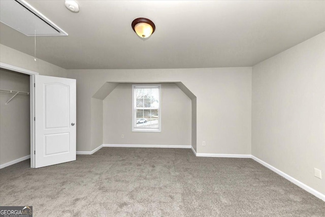 bonus room featuring light carpet