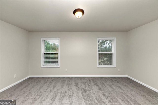 unfurnished room featuring light carpet