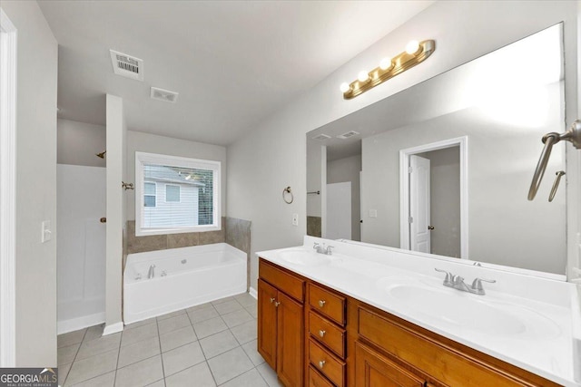 bathroom with vanity, a tub, and tile patterned flooring