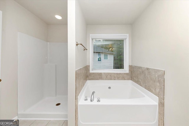 bathroom featuring a tub to relax in and tile patterned flooring