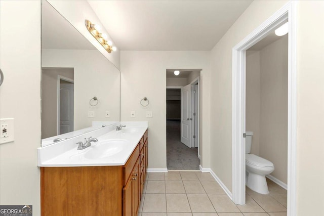 bathroom featuring toilet, tile patterned floors, and vanity