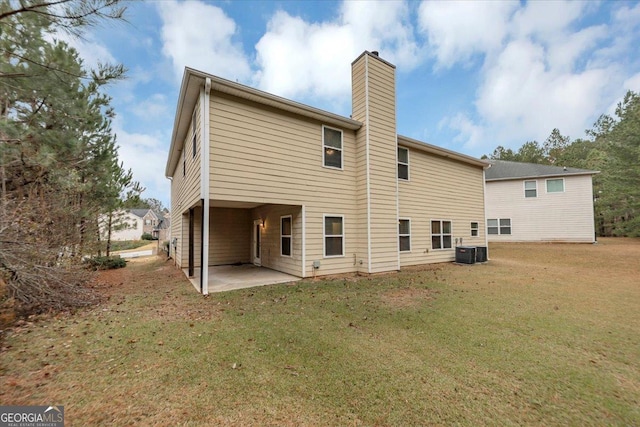 back of property featuring a lawn, a patio, and central AC