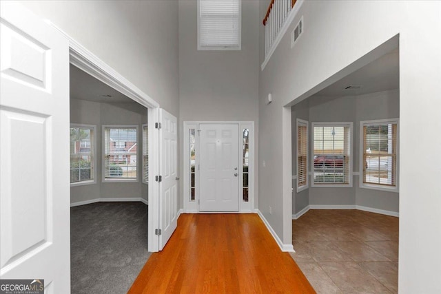 entrance foyer with a high ceiling and tile patterned floors