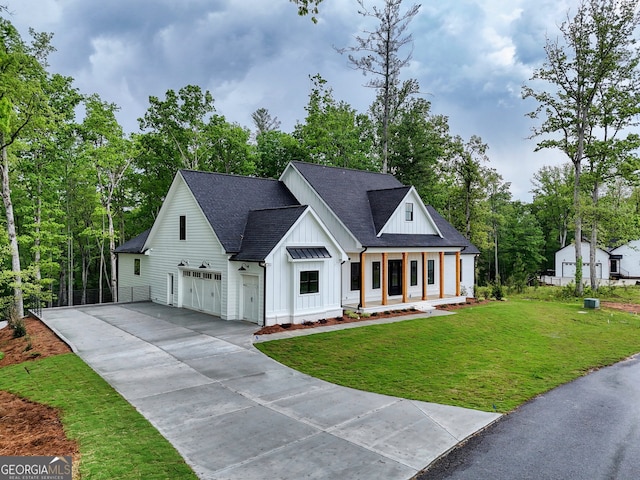 modern farmhouse with board and batten siding, covered porch, driveway, a front yard, and roof with shingles