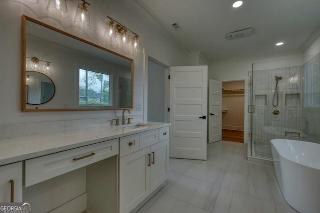 full bath with a walk in closet, a shower stall, vanity, ornamental molding, and recessed lighting