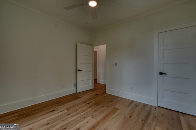 unfurnished room featuring crown molding, a ceiling fan, baseboards, and light wood finished floors