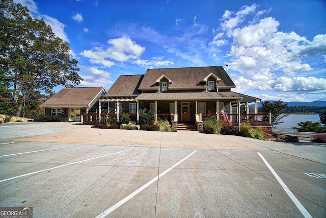 country-style home featuring covered porch and uncovered parking