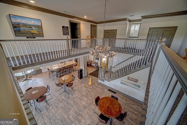 interior space with crown molding, recessed lighting, wood finished floors, and visible vents