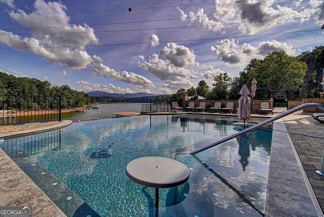 pool featuring fence and a patio