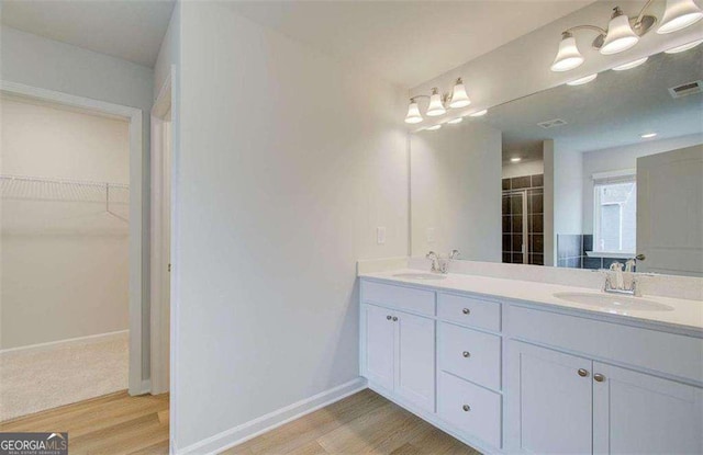 bathroom featuring vanity, hardwood / wood-style flooring, and an enclosed shower