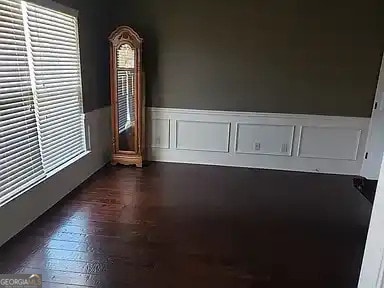 unfurnished room featuring dark hardwood / wood-style flooring