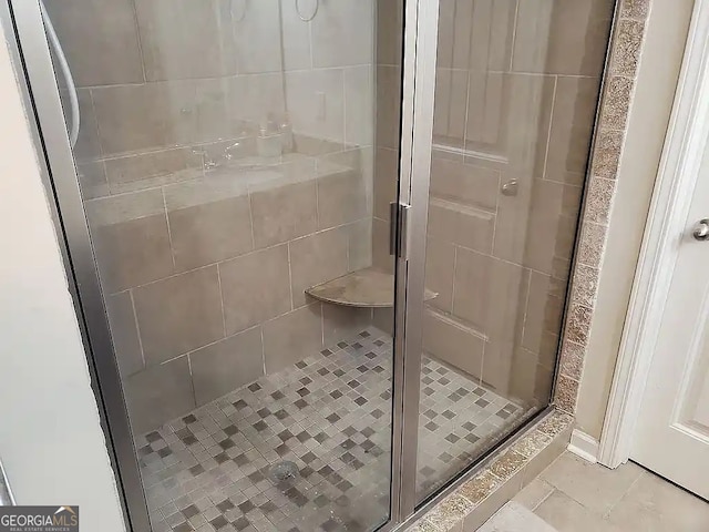 bathroom featuring tile patterned floors and an enclosed shower