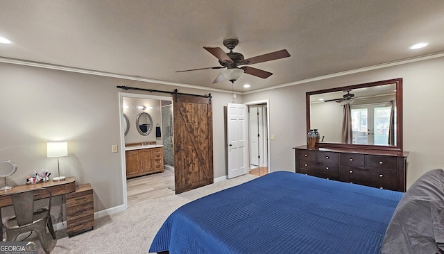 bedroom with ensuite bath, light carpet, ornamental molding, ceiling fan, and a barn door