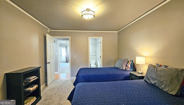 carpeted bedroom with crown molding and connected bathroom