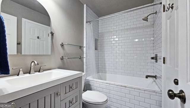 full bathroom featuring vanity, toilet, and tiled shower / bath combo