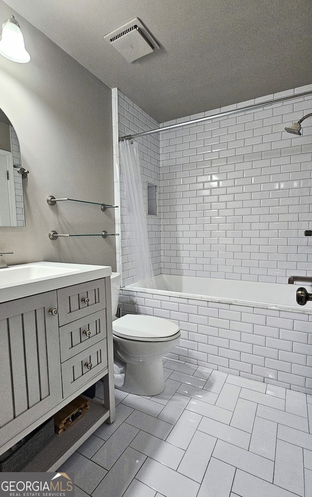 full bathroom featuring vanity, tile patterned flooring, shower / bath combination with curtain, and toilet