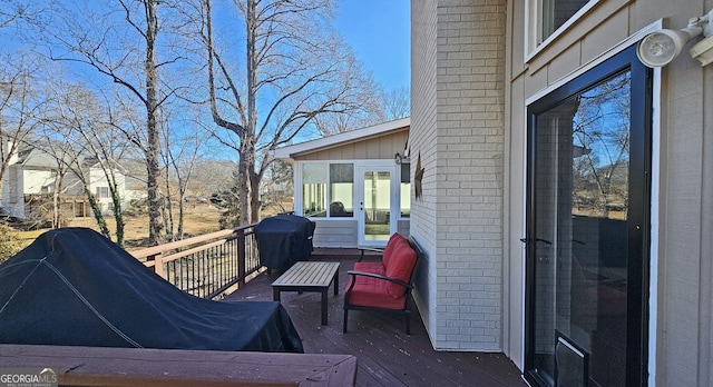 wooden terrace with grilling area and french doors