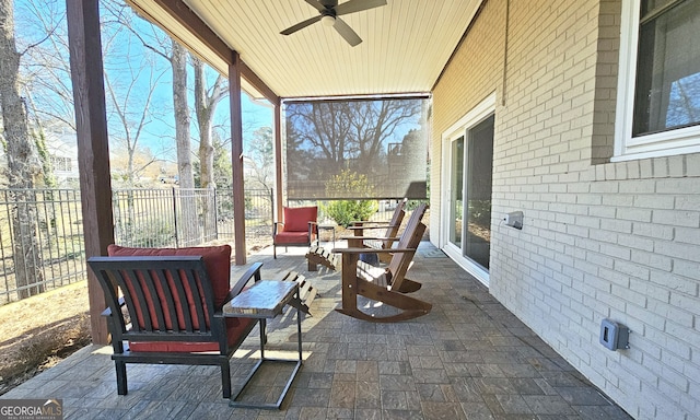 sunroom / solarium with a wealth of natural light and ceiling fan