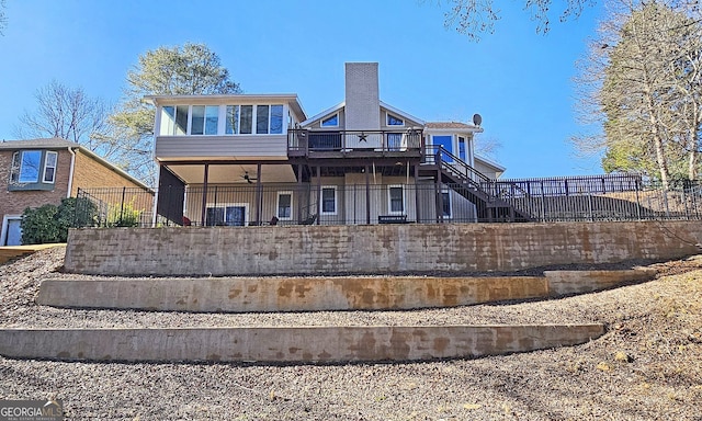 back of property with a sunroom and ceiling fan