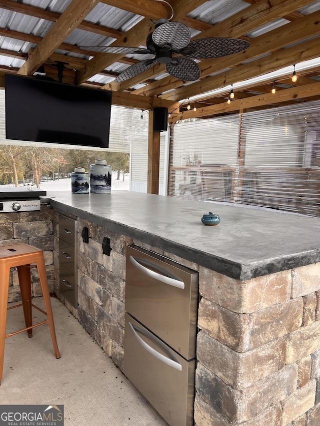 view of patio with an outdoor bar and ceiling fan