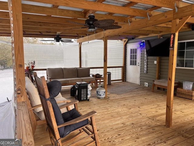 wooden terrace featuring an outdoor hangout area and ceiling fan