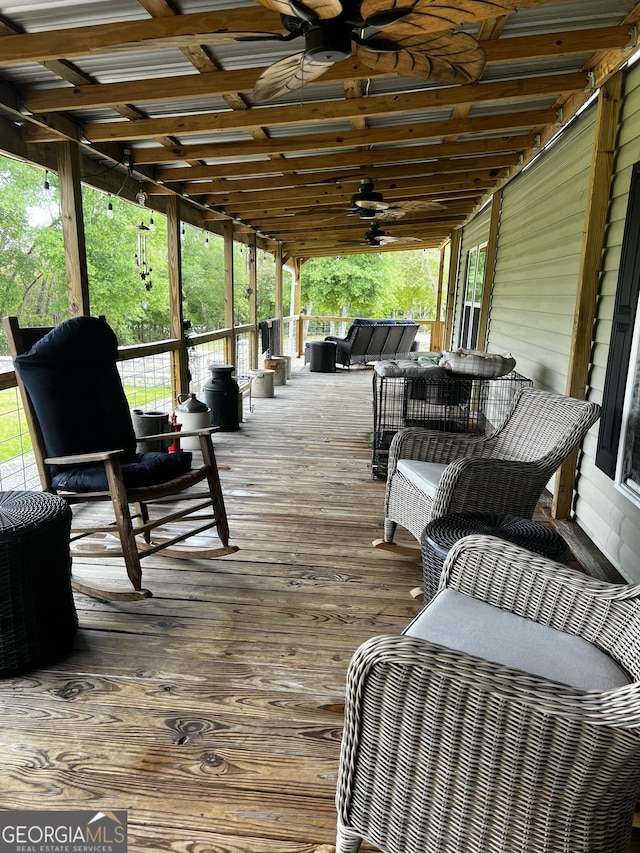 wooden terrace featuring an outdoor hangout area and ceiling fan